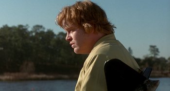 Movie still from “Love Liza” (2002), directed by Todd Louiso – A man with blonde hair is looking to his left; Close Up shot, Over the shoulder angle
