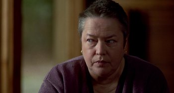 Movie still from “Love Liza” (2002), directed by Todd Louiso – An older woman is looking at the camera; Close Up shot, Over the shoulder angle