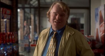 Movie still from “Love Liza” (2002), directed by Todd Louiso – A man in a yellow jacket and a blue shirt; Medium shot, Over the shoulder angle