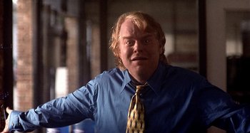 Movie still from “Love Liza” (2002), directed by Todd Louiso – A man in a blue dress shirt and a yellow neck tie; Close Up shot, Over the shoulder angle