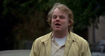 Movie still from “Love Liza” (2002), directed by Todd Louiso – A person wearing a shirt and a jacket; Close Up shot, Low angle