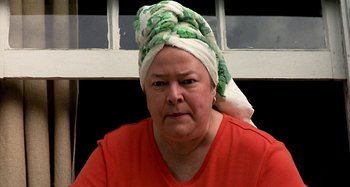 Movie still from “Love Liza” (2002), directed by Todd Louiso – A woman with a towel wrapped around her head; Close Up shot, Low angle
