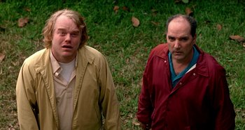 Movie still from “Love Liza” (2002), directed by Todd Louiso – Two men standing next to each other in a grassy area; Close Up shot, Low angle
