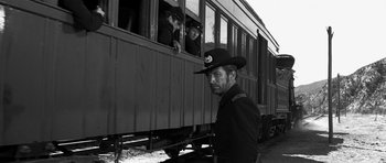 Movie still from “Love Me Tender” (1956), directed by Robert D. Webb – A black and white photo of a man in a uniform; Medium shot, Low angle