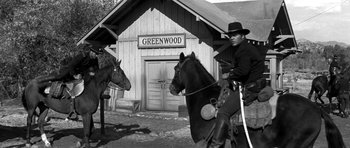 Movie still from “Love Me Tender” (1956), directed by Robert D. Webb – A black and white photo of a man riding a horse; Wide shot, Low angle