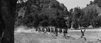 Movie still from “Love Me Tender” (1956), directed by Robert D. Webb – A black and white photo of a group of men on horses; Extreme Wide shot, Low angle