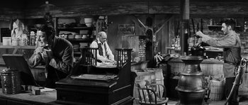 Movie still from “Love Me Tender” (1956), directed by Robert D. Webb – An old man is working in a shop; Wide shot, High angle