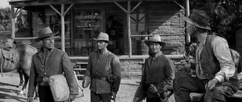 Movie still from “Love Me Tender” (1956), directed by Robert D. Webb – A couple of men standing next to each other on a dirt road; Wide shot, Low angle