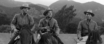 Movie still from “Love Me Tender” (1956), directed by Robert D. Webb – A black and white photo of a man on a horse; Medium shot, Low angle