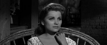 Movie still from “Love Me Tender” (1956), directed by Robert D. Webb – A black - and - white photo of a woman in a dress; Close Up shot, Low angle