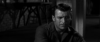 Movie still from “Love Me Tender” (1956), directed by Robert D. Webb – Black and white photograph of a man in a room; Close Up shot, Over the shoulder angle