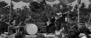 Movie still from “Love Me Tender” (1956), directed by Robert D. Webb – A group of men performing on a stage with instruments; Wide shot, Low angle