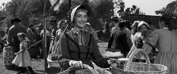 Movie still from “Love Me Tender” (1956), directed by Robert D. Webb – An old photo of a woman sitting in a basket; Medium shot, Low angle