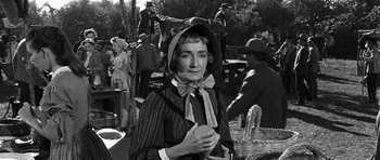 Movie still from “Love Me Tender” (1956), directed by Robert D. Webb – An old photo of an old woman in a bonnet; Medium shot, Over the shoulder angle