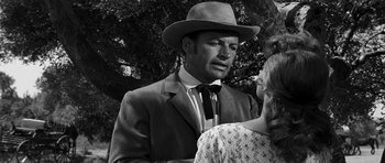 Movie still from “Love Me Tender” (1956), directed by Robert D. Webb – A black and white photo of a man and a woman; Close Up shot, Over the shoulder angle