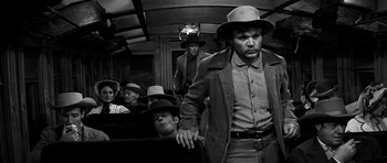 Movie still from “Love Me Tender” (1956), directed by Robert D. Webb – A black and white photo of men on a train; Medium shot, Low angle