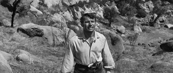 Movie still from “Love Me Tender” (1956), directed by Robert D. Webb – An old black and white photo of a man with a camera in his hand; Medium shot, Low angle