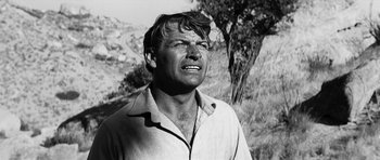 Movie still from “Love Me Tender” (1956), directed by Robert D. Webb – An old black and white photo of a man; Close Up shot, Low angle