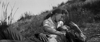 Movie still from “Love Me Tender” (1956), directed by Robert D. Webb – An old photo of a woman holding a baby in her arms; Medium shot, Low angle