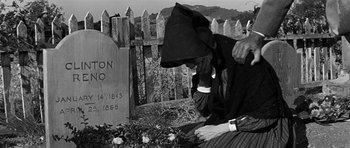 Movie still from “Love Me Tender” (1956), directed by Robert D. Webb – An old photo of a person in a graveyard; Close Up shot, Low angle