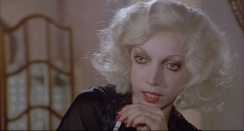 A person holding a cigarette in her mouth