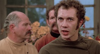 Movie still from “Love and Death” (1975), directed by Woody Allen – A group of men standing next to each other in front of a window; Close Up shot, Low angle