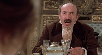 Movie still from “Love and Death” (1975), directed by Woody Allen – An old man sitting in front of a tea pot; Close Up shot, Over the shoulder angle