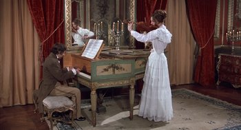 Movie still from “Love and Death” (1975), directed by Woody Allen – A man and a woman playing a violin and a piano; Wide shot, High angle