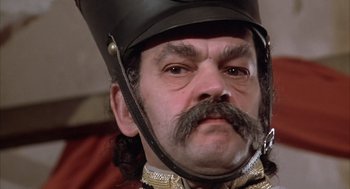 Movie still from “Love and Death” (1975), directed by Woody Allen – A person wearing a helmet; Close Up shot, Low angle