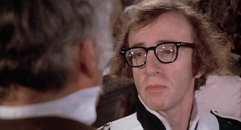 Movie still from “Love and Death” (1975), directed by Woody Allen – An older woman wearing glasses looking at the camera; Close Up shot, Over the shoulder angle
