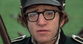 Movie still from “Love and Death” (1975), directed by Woody Allen – A person wearing glasses and a helmet; Close Up shot, Low angle