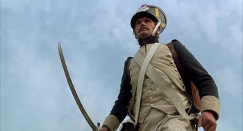 Movie still from “Love and Death” (1975), directed by Woody Allen – A man in a uniform holding a sword in his hand; Medium shot, Low angle