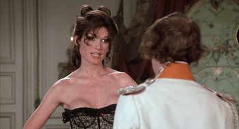 Movie still from “Love and Death” (1975), directed by Woody Allen – A woman in a black and white dress and a man in a white shirt; Medium shot, Over the shoulder angle