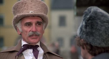 Movie still from “Love and Death” (1975), directed by Woody Allen – An older man wearing a fur hat and a tie; Close Up shot, Low angle