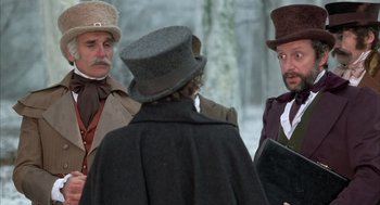Movie still from “Love and Death” (1975), directed by Woody Allen – A group of men standing next to each other in a forest; Medium shot, Over the shoulder angle