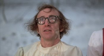 Movie still from “Love and Death” (1975), directed by Woody Allen – A man wearing glasses and a white shirt looking up; Close Up shot, Over the shoulder angle