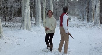 Movie still from “Love and Death” (1975), directed by Woody Allen – Two people standing in the snow near a forest; Wide shot, Low angle