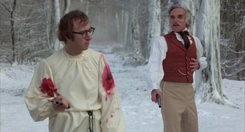 Movie still from “Love and Death” (1975), directed by Woody Allen – Two men in the woods with blood on their clothes; Medium shot, Over the shoulder angle