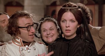 Movie still from “Love and Death” (1975), directed by Woody Allen – A group of people standing next to each other; Close Up shot, Over the shoulder angle
