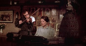 Movie still from “Love and Death” (1975), directed by Woody Allen – A man and a woman are playing a violin; Medium shot, Low angle