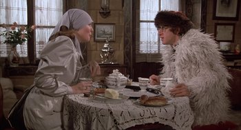 Movie still from “Love and Death” (1975), directed by Woody Allen – Two women are sitting at a table with food on it; Medium shot, Over the shoulder angle