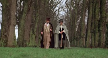 Movie still from “Love and Death” (1975), directed by Woody Allen – Two men dressed in period costumes in a park; Wide shot, Low angle