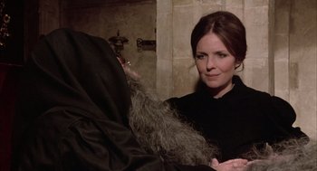 Movie still from “Love and Death” (1975), directed by Woody Allen – A woman standing next to an older man; Medium shot, Over the shoulder angle