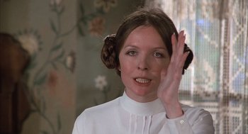 Movie still from “Love and Death” (1975), directed by Woody Allen – A young woman in a white shirt with her hand up to her face; Close Up shot, Low angle