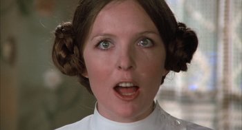 Movie still from “Love and Death” (1975), directed by Woody Allen – A young woman with brown hair wearing a white shirt; Close Up shot, Low angle
