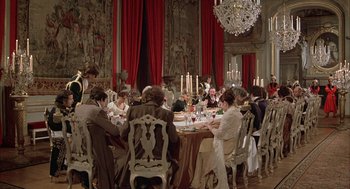 Movie still from “Love and Death” (1975), directed by Woody Allen – A group of people sitting at a table with food; Wide shot, High angle