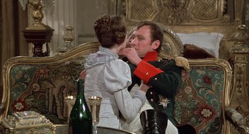 Movie still from “Love and Death” (1975), directed by Woody Allen – A man and a woman are kissing in a room; Medium shot, Over the shoulder angle