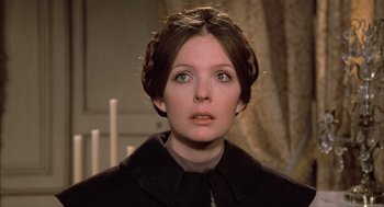 Movie still from “Love and Death” (1975), directed by Woody Allen – A person wearing a coat; Close Up shot, Over the shoulder angle