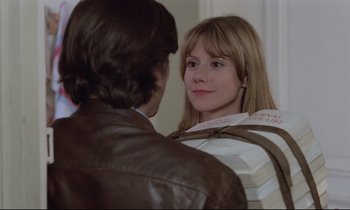 Movie still from “Love on the Run” (1979), directed by François Truffaut – A man and a woman looking at each other; Medium shot, Over the shoulder angle