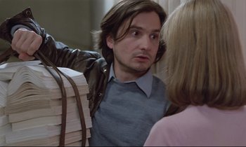 Movie still from “Love on the Run” (1979), directed by François Truffaut – A man and a woman standing next to each other in a room; Medium shot, Over the shoulder angle